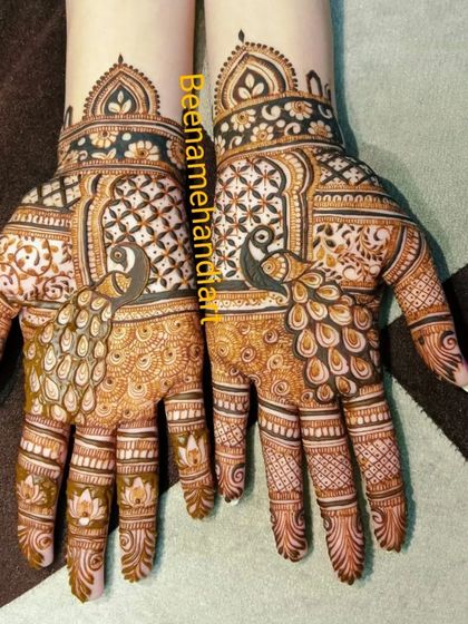 A pair of hands with matching peacock designs inside architectural frames.