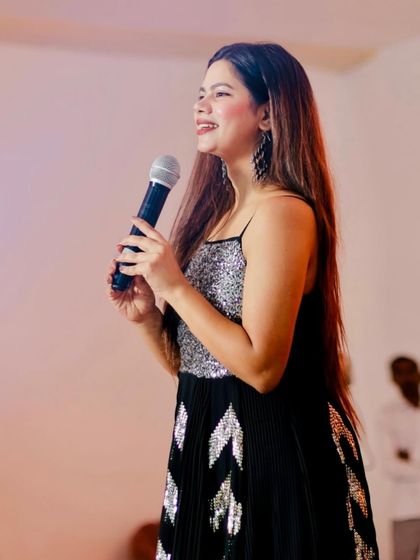 A profile shot of me on stage, focused on the event's proceedings. Even in high-energy moments, I keep the event flow on track.