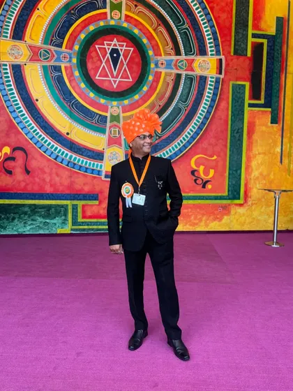 Standing in front of a large, vibrant mural after the award ceremony. The colours of the art behind me reflect the joy I felt on this day.