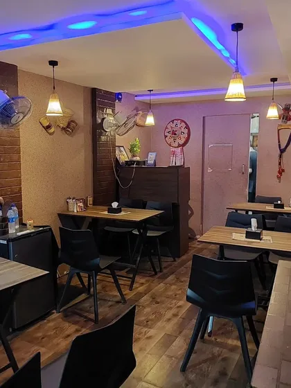 A look at our dining space before the evening rush. The wooden tables, simple chairs, and warm lighting are all chosen to create a comfortable and welcoming vibe.