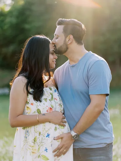 There's something magical about a sunset session. Here, the golden light wraps around this beautiful couple, highlighting the tender kiss and the promise of their growing family. Outdoor maternity photography in a natural setting like this feels so timeless.