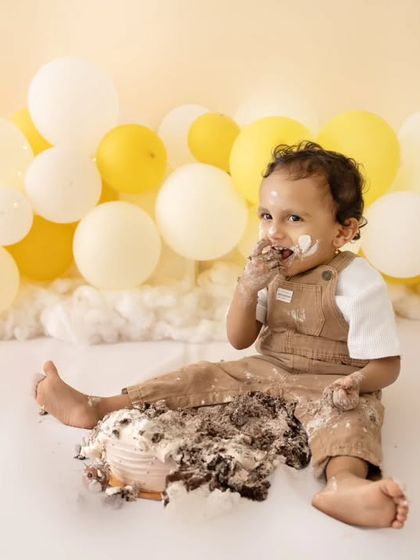 He's definitely enjoying that cake. A messy and happy close-up from the cake smash session.