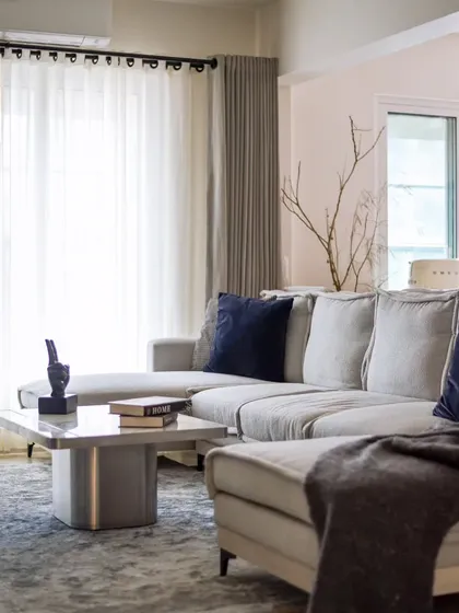 Another view of the plush sofa and custom marble coffee table. The space is designed to be a comfortable and stylish retreat from the hustle and bustle of the city.