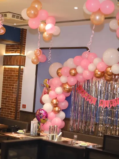 A wider view of the restaurant space decorated for the princess birthday party.