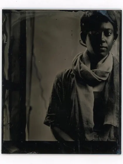 A quiet, contemplative portrait made using the wet plate collodion process. The subtle imperfections and unique artifacts on the glass plate add to the image's character.