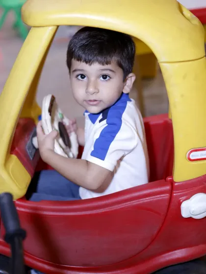 Another happy driver in our play area. The ride-on cars are perfect for toddlers and young children.