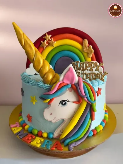 A magical unicorn cake is always a favorite. This one features a golden horn, a rainbow mane, and a colorful rainbow backdrop, all made from fondant and creamy frosting. It’s designed to bring a burst of color and happiness to any kid's birthday.