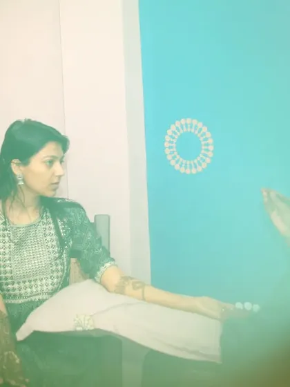 A behind-the-scenes shot of the mehandi artist at work. We document the entire process to tell a complete story of your wedding preparations.