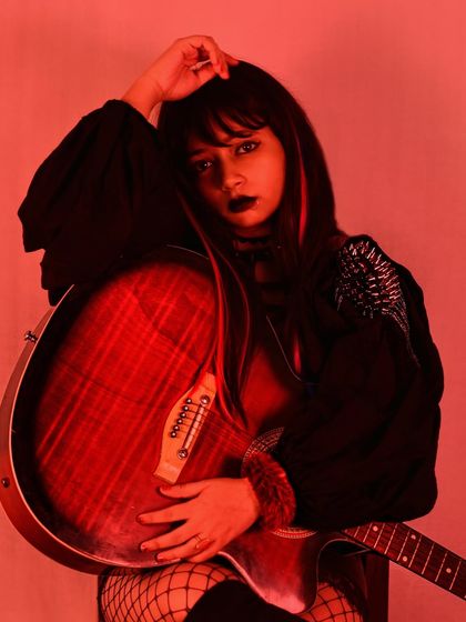 This is the power of styling. A glimpse into my portfolio showing a punk-inspired look with a black top, fishnet stockings, and dark makeup. It's all about creating a character and telling a story through fashion.