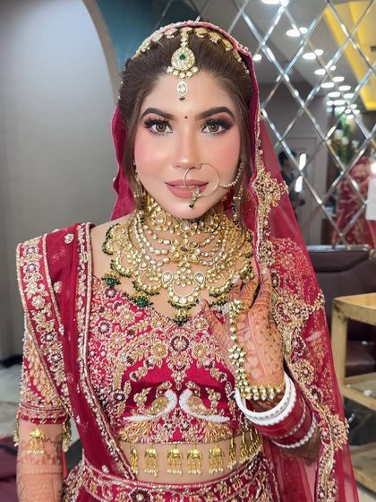 This bride wanted a "glass skin" look for her wedding day. I focused on creating a super dewy, reflective base with sharp, defined eyes and a neutral lip color to balance her ornate red lehenga.