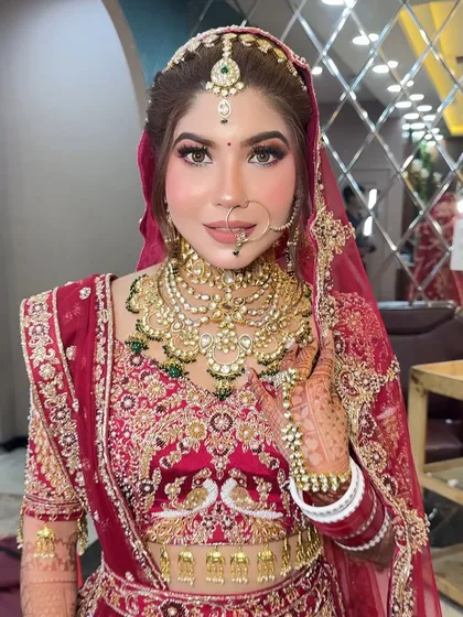 This bride wanted a "glass skin" look for her wedding day. I focused on creating a super dewy, reflective base with sharp, defined eyes and a neutral lip color to balance her ornate red lehenga.
