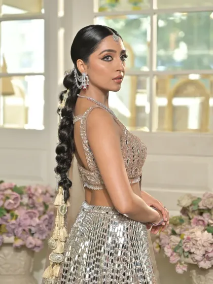 A side profile showcasing the sleek ponytail base that flows into the accessorized bubble braid. This highlights the versatility of the style, which is both elegant from the front and dramatic from the back.