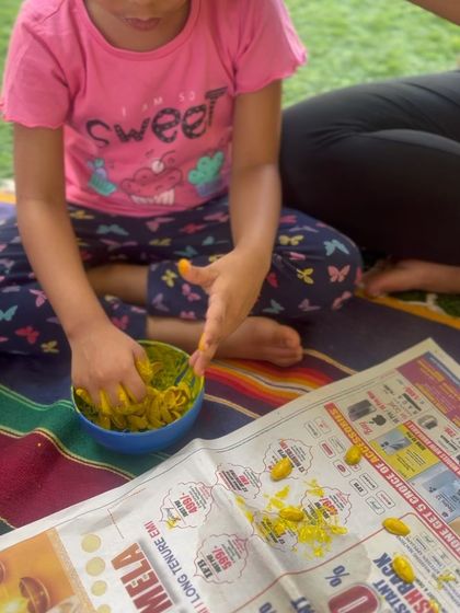 Art and craft activities are crucial for toddler development. This image captures a child engaged in messy play, which stimulates the senses and fosters creativity.