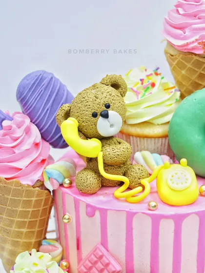 A close-up of the adorable teddy bear figurine talking on a retro telephone.