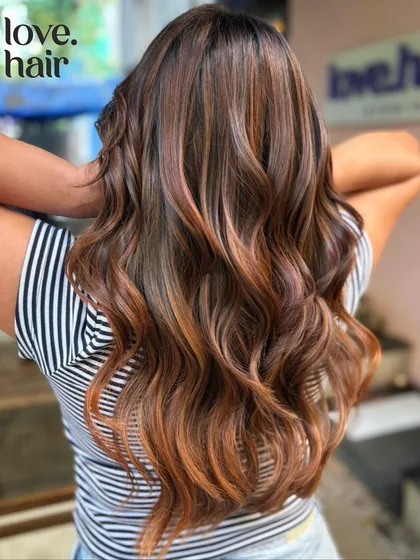 We call this look glitter and honey. A warm, non-bleach balayage with coppery and golden tones that create a beautiful, shimmering effect on long hair.
