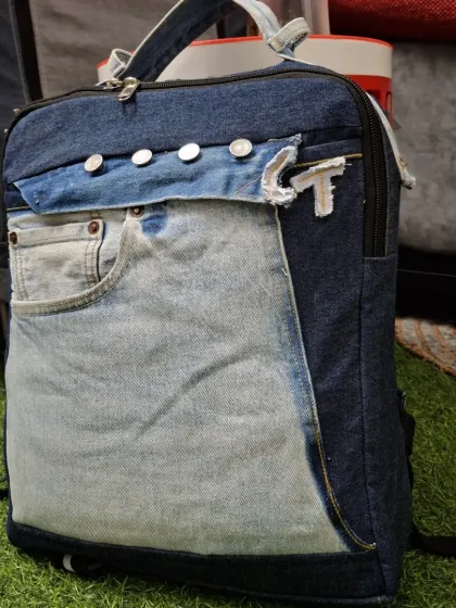 Don't throw away your old jeans. I can upcycle them into a durable and stylish backpack like this one. Notice how I've used the original pockets and waistband to create a functional and one-of-a-kind accessory.