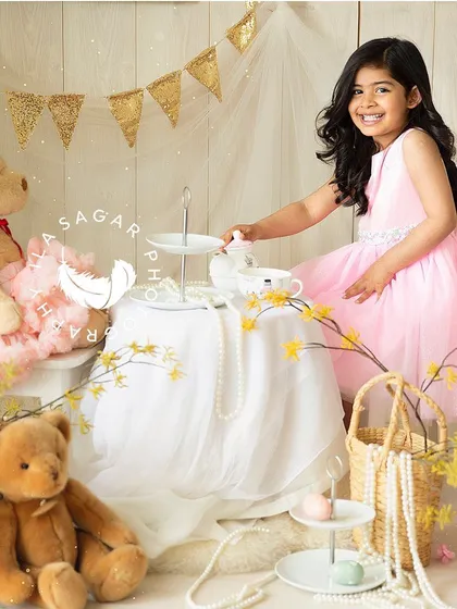 For toddlers, playtime is everything. I created this sweet teddy bear tea party scene to let her personality shine, resulting in this beautiful, natural smile. These sessions are about capturing their imagination at play.