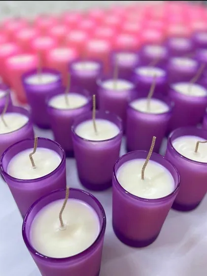 We love creating customized wedding favors. These shot glass candles in vibrant purple and pink are perfect for adding a pop of color to your event. We can personalize them to match your wedding theme.