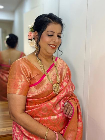 A smiling portrait, showing off her beautiful makeup and hair.