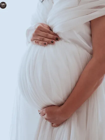 Sometimes the most powerful images are the simplest. This close-up shot focuses on the baby bump, using soft, bright lighting to create a tender and intimate portrait that you will cherish forever.
