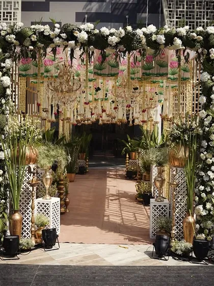 The same grand entrance from image 305, showcasing the intricate details of the floral work, hanging chandeliers, and Pichwai-inspired elements.