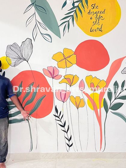 "She designed a life she loved." This boho foliage mural incorporates an inspirational quote, blending colorful abstract shapes with delicate floral line art for a truly personal touch.