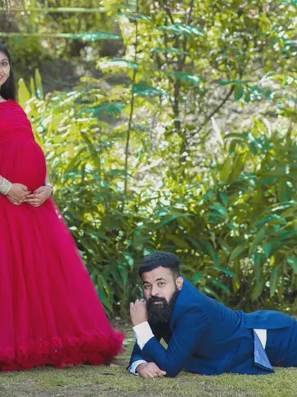A fun and relaxed couple's portrait featuring the red flowy gown. This comfortable and elegant dress is perfect for capturing both posed and candid moments during your maternity photoshoot.