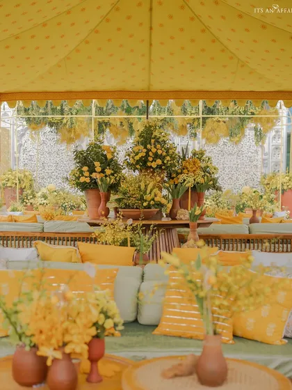 A view from within a seating lounge, showing the layers of yellow florals and textiles that filled the space.