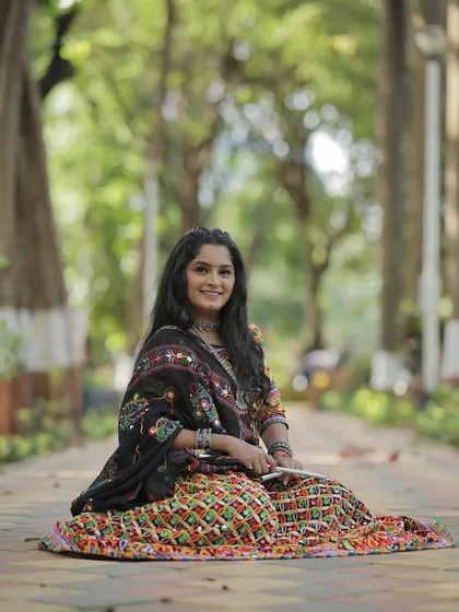 A beautiful portrait of my client ready for Navratri. Her traditional mirror-work ghagra choli is paired with silver jewelry and long, wavy hair.