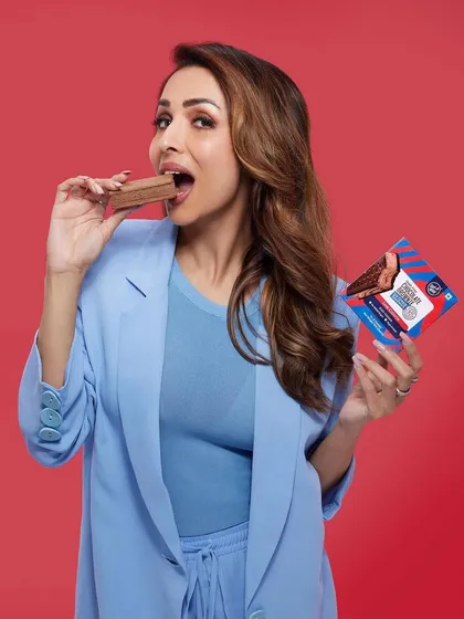 Another look from the Getaway Desserts campaign with Malaika Arora, featuring a sleek and powerful hairstyle that complements her bold, colour-blocked outfit.