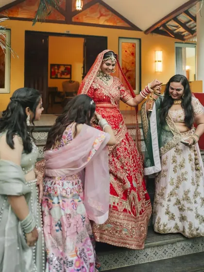 A fun and candid moment as the bride interacts with her bridesmaids during the Kalire ceremony.