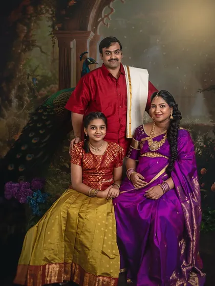 A complete family portrait in the Raja Ravi Varma style. The composition is carefully arranged to reflect classical portraiture, celebrating the family's bond and the anticipation of a new member.