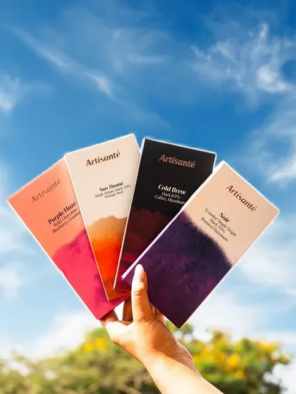 This user-generated content (UGC) style shot for Artisante chocolates showcases the product in a natural, outdoor setting. It feels authentic and is perfect for creating relatable social media content.