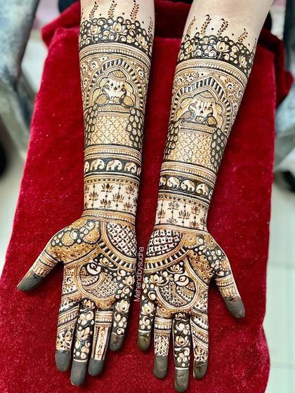 A beautiful bridal design featuring traditional jharokha windows with elephants, surrounded by fine dot work and floral patterns.