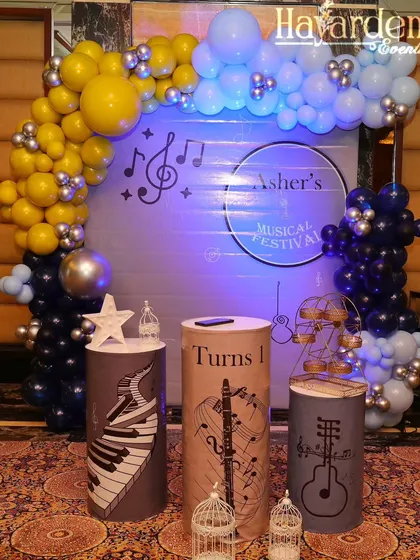 A unique musical festival theme for a first birthday. I used custom-wrapped plinths with piano and guitar graphics and a personalized backdrop.