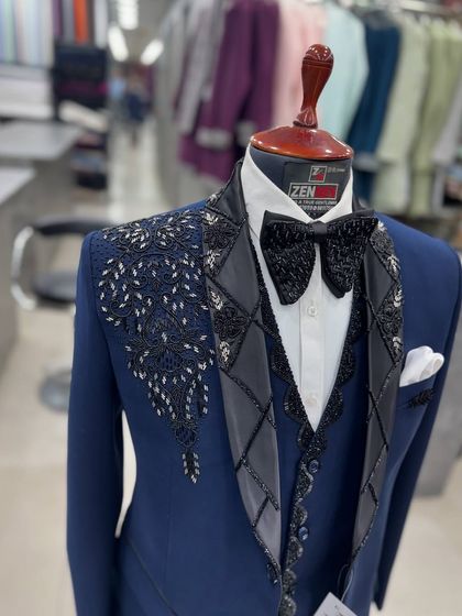 A closer look at the lapel of the navy blue tuxedo. The combination of floral embroidery and a leather-like diamond pattern creates a fascinating mix of textures.