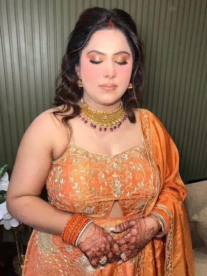 A close-up of her makeup, the gold jewelry adding warmth to her look.