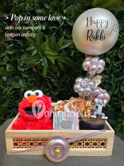 Pop in some love with our hampers and balloon artistry. This Rakhi basket is perfect for a younger sibling, featuring an Elmo plush toy and a fun Tom and Jerry figurine.