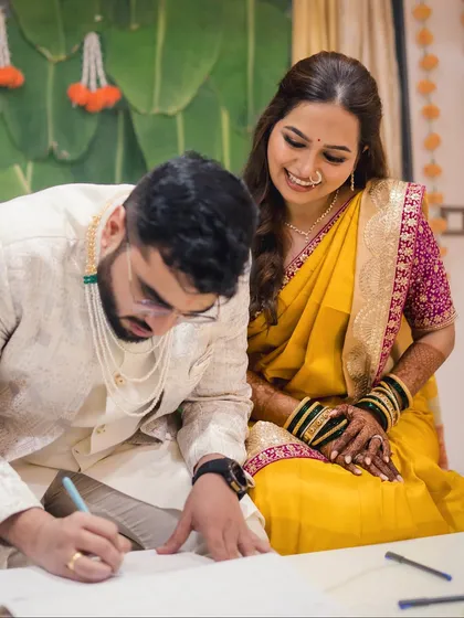 A candid moment during the marriage registration. The bride's soft makeup looks flawless and natural as she shares a happy moment with her partner.