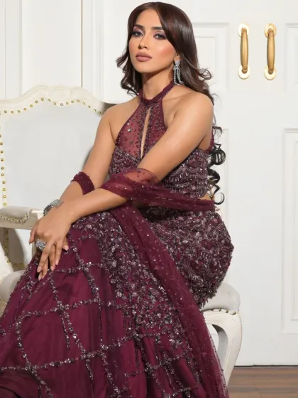 A confident and poised portrait. The makeup enhances her features, with a focus on creating a luminous and polished finish.