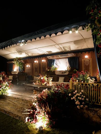 The main lounge area of the "Golden Rails" event, designed to look like a luxurious train compartment. The space featured rich wood paneling, plush seating, and windows showing curated travel landscapes.