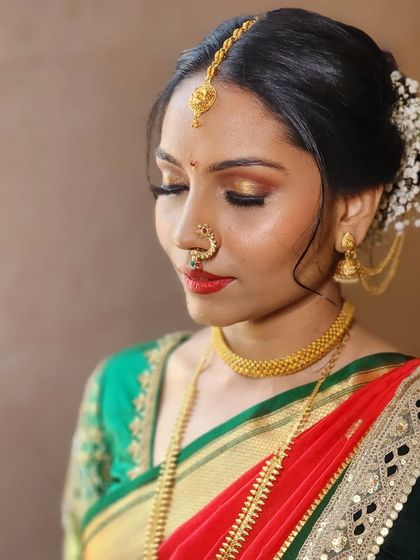 Radiant and bold. This look features glowing skin, a classic red lip, and defined eyes, creating a powerful and beautiful statement for a traditional wedding.