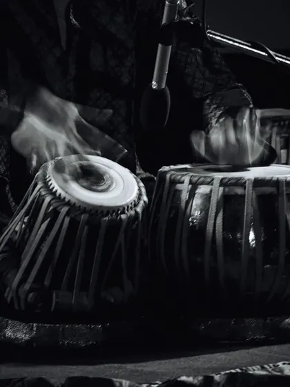 An artistic shot of the tabla in motion. The blur captures the speed and energy of the hands, representing the 'blast from the past' and the timeless power of rhythm.