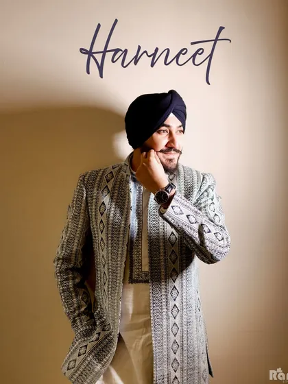 The groom's story is an essential part of the day. This portrait of a Sikh groom in his elegant sherwani and turban is a stylish, confident shot that highlights his personality and anticipation before the ceremony.