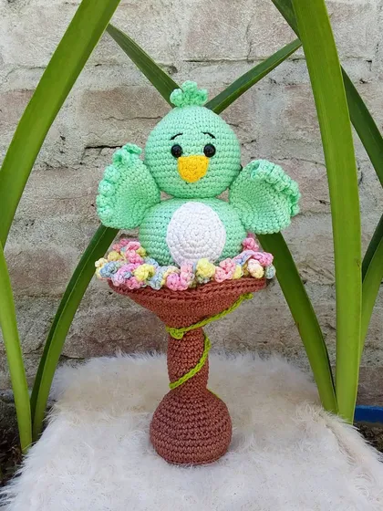 This is Koda the bird, enjoying his little birdbath filled with colorful flowers. This set is a beautiful decorative piece.