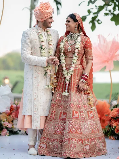 A beautiful portrait of our couple during their summer wedding, where we used a unique burnt orange and peach color palette for the decor and floral arrangements.