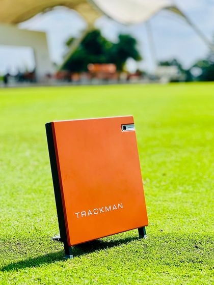 The iconic orange box of the TrackMan launch monitor. This tool is a constant presence on our range, providing instant, accurate data on ball flight, club speed, and impact dynamics. It is essential for structured, effective practice.