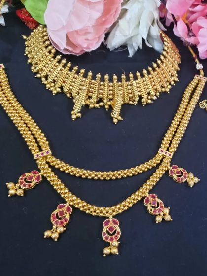 The Maharashtrian jewellery set she rented. This includes a traditional beaded choker and a longer necklace with pink stone accents.