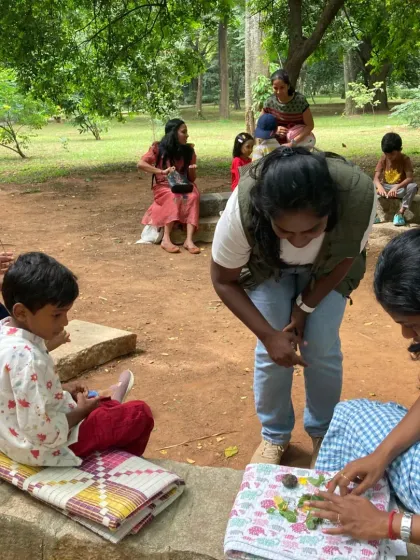 An instructor helps a child with a nature art activity that follows our story time. We believe in learning by doing, and this creative exercise helps solidify the themes and characters from the story.