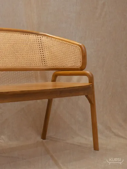The 'Romanji' bench from another angle, showing the full length of the woven rattan backrest. It's a statement of artistry and quality for your home.